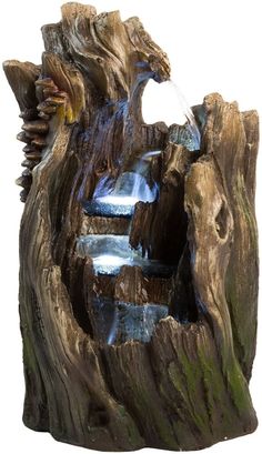 an animal statue made out of wood with water running down it's face and mouth