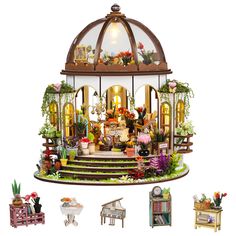 a doll house with lots of furniture and flowers on it's display stand, including a piano