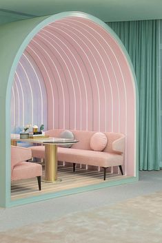 a living room filled with pink couches and chairs