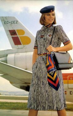 a woman is standing in front of an airplane with her luggage on her shoulder and smiling at the camera