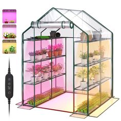 a green house with plants inside and an electrical plugged into the wall next to it