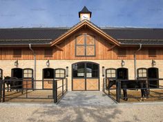 the horses are standing in their stalls at the stable