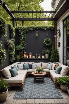 an outdoor living area with couches, tables and potted plants