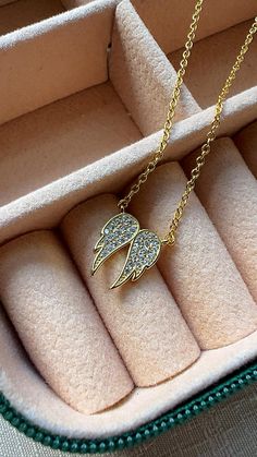 Embrace elegance and spirituality with our 14K gold-plated angel wings necklace, featuring shimmering Cubic Zirconia stones for added sparkle. This timeless piece is designed to inspire and make a statement, perfect for everyday wear or as a meaningful gift for someone special. With its high-quality craftsmanship and affordable price, this necklace blends luxury and style effortlessly, making it a must-have addition to any jewelry collection. At Jewelrybyana ,we are committed to offering on-trend jewelry at prices that don't break the bank.  Follow us on Instagram @jewelrybyanashop to see how others are styling their new favorite pieces. Tag us in your photos to be featured and join our community of jewelry lovers! Wings Necklace, Gold Angel Wings, Trend Jewelry, Angel Wing Necklace, Angel Wing Pendant, Gold Angel, Trending Necklaces, Wing Necklace, Dope Jewelry