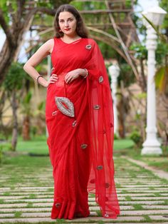 This is a three-piece red lip saree set from the Ensembles collection. The red lip saree is paired with a red sleeveless blouse. The blouse has a round neckline. There are beautiful lip motifs of shimmer cutdana work all over the saree. This saree set is crafted in semi pure organza fabric. The outfit is completed with a heavily embellished, cutdana work shimmer lip shape handbag. Designer Red Blouse Piece With Sheer Dupatta, Designer Red Pre-draped Saree For Diwali, Red Pre-draped Designer Saree For Diwali, Traditional Red Pre-draped Saree For Evening, Designer Red Pre-draped Saree With Self Design, Red Pre-draped Saree With Sheer Dupatta For Designer Wear, Red Saree For Evening With Traditional Drape, Red Evening Saree With Traditional Drape, Red Pre-draped Saree With Zari Work For Evening