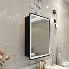 a bathroom with a sink, mirror and flowers