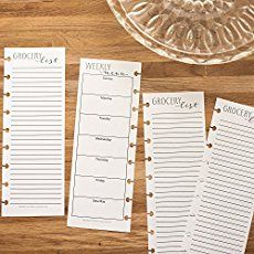 three lined paper with writing on them sitting next to a glass bowl and an empty plate