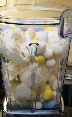 a blender filled with white and yellow candies