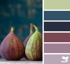 three figurines sitting next to each other on top of a table with color swatches