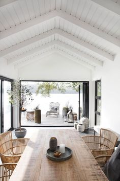 a table and chairs in a room with an open floor plan on the wall next to it