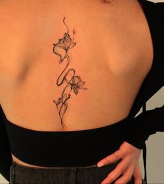 the back of a woman's shoulder with flowers on it