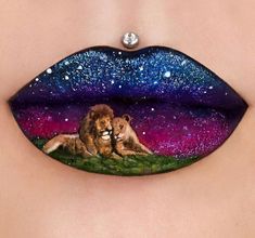 a woman's lips with the image of two lions painted on them and stars in the sky