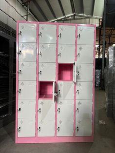 several lockers with pink and white doors in a storage area at a warehouse or facility