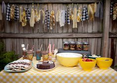 a table topped with desserts and drinks on top of a checkered table cloth