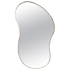 an oval shaped mirror on a white background with gold trimmings and a curved edge