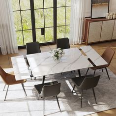 a dining room table with chairs and a vase on the table in front of large windows