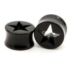 two black plastic knobs with stars on the top and one has a white background