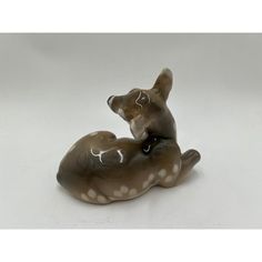 a ceramic figurine of a cat laying down