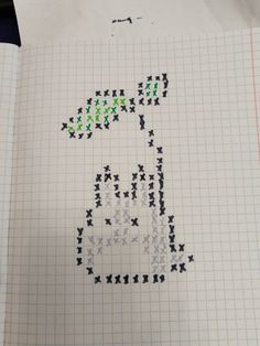 a piece of paper that has some type of cross stitch pattern on it, with the letter d in green