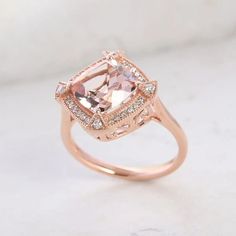 This Luxoro 10K rose gold ring for women features a AAA Marropino morganite gemstone in a halo design, symbolizing eternal love and commitment. The cushion-shaped morganite centerpiece, encircled by round diamonds, is finely and skillfully cut for captivating sparkle and durability. Gold Ring For Women, Morganite Gemstone, Halo Design, Tanzanite Diamond, Gold Chain Jewelry, Morganite Ring, Signature Jewelry, Cross Jewelry, Blue Zircon