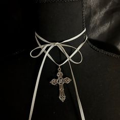 This necklace has a long white ribbon and a metal cross pendant, intended to be wrapped multiple times around the neck. It is about 62 inches long. Tactical Wear, Wrap Necklace, Ribbon Necklace, Metal Cross, Wrap Necklaces, White Ribbon, A Metal, Dream Clothes, Cross Pendant