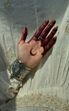 a woman's hand with red paint on it