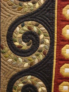 a close up view of a quilted wall hanging