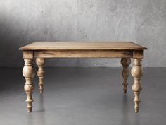 a wooden table sitting on top of a cement floor