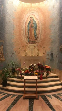 the interior of a church with flowers on the steps and an altar in the center