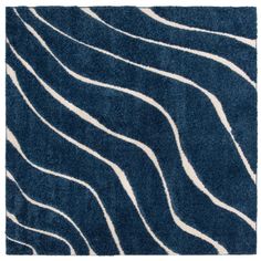 a blue rug with wavy lines on the bottom and white stripes in the middle, against a white background