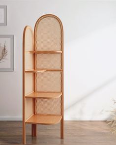 a wooden shelf sitting on top of a hard wood floor next to a white wall