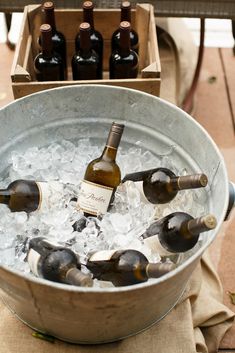 several bottles of wine are in an ice bucket