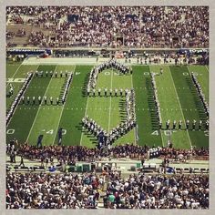 an aerial view of a football field with the words love spelled out in front of it