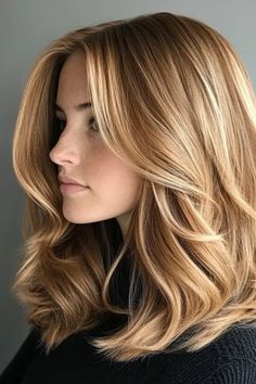 Woman with shoulder-length, wavy, golden blonde hair in a side profile. Honey Blonde Hair With Strawberry Highlights, Winter Golden Blonde Hair, Darkish Blonde Hair, Expensive Honey Hair Color, Golden Highlights Blonde Hair, Virgin River Mel Hair, Blond Honey Hair, Medium Length Honey Blonde Hair, Golden Brown Hair Honey Highlights