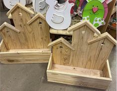 several wooden birdhouses are stacked on top of each other