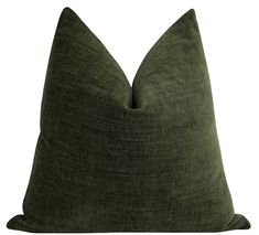 a dark green pillow on a white background