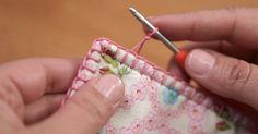 someone is stitching the end of a piece of fabric