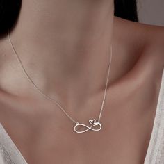 "Infinity Necklace with Hearts Necklace is made by hand in our workshop with care. All our jewelry is the most elegant choice for the Bridesmaids, friends, your loved ones and for yourself. Infinity Necklace with Hearts Necklace * Material: High Quality Solid 925 Sterling Silver. * Dimensions: Depending on your font choice, height sizes range from 1,5 mm to 3,5 mm lowercase. * Finish: Sterling Silver ∙ Gold ∙ Rose Gold. HOW TO ORDER ❓ * Select your necklace COLOR. * Choose necklace length from 14\" to 22\". The length option is the TOTAL chain length (including the charm). If you order an 18\" chain, the piece will come as CHAIN + CHARM = 18\".  * Finish your payment and complete your order. PRODUCTION TIME 🕒 All items made to order. Production starts within 12 hours and ships within 24 h Infinity Heart Necklace In Sterling Silver For Gift, Sterling Silver Infinity Heart Necklace As Gift, Heart Rate Tattoo, Heart And Infinity, Minimalist Necklace Silver, Fancy Jewelry Necklace, Handmade Gold Jewellery, Infinity Jewelry, Infinity Pendant