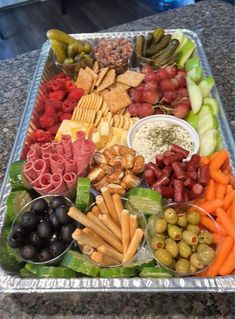 a platter filled with different types of food on top of a counter next to other foods