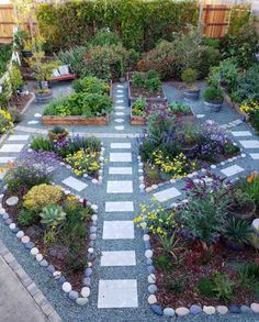 a garden with many different types of flowers and plants in it's center area