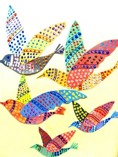 several colorful birds are flying in the air with polka dots on their body and wings