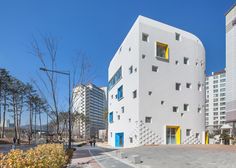 a white building with yellow and blue windows