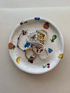 a white plate topped with lots of different types of rings