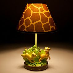 a giraffe lamp sitting on top of a table