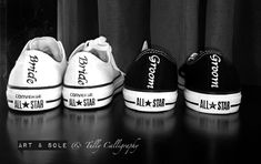 black and white photograph of three converse shoes with the word all star painted on them