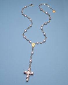 Add some heavenly style to your look with our Pearl Virgin Mary Cross Rosary. Featuring freshwater pearls and a delicate rosary and cross necklace design, this piece is perfect for daily wear or special occasions. The sparkling cubic zirconia accents add a touch of divine sparkle. Amen to that! 18k gold-plated, freshwater pearl, cubic zirconia 14" necklace | 2" extension chain | 8 mm pearls | 2" drop with 1.5" cross pendant Multiple sizes are available Handmade in Los Angeles with imported mater Rosary Style Beaded Necklace, Pearl Necklace With Cross, Virgin Mary Rosary, Gold Rosary Necklace, Wedding Rosary, Winter Wishlist, Pearl Cross Necklace, Handmade Rosary, Cross Rosary