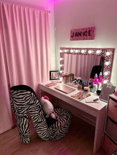 a zebra print high heeled shoe sits in front of a vanity with a mirror and lights