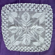 a white doily on a purple background