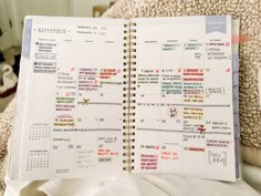 an open planner sitting on top of a bed