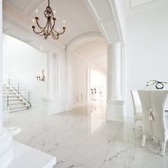 a white room with marble floors and chandelier